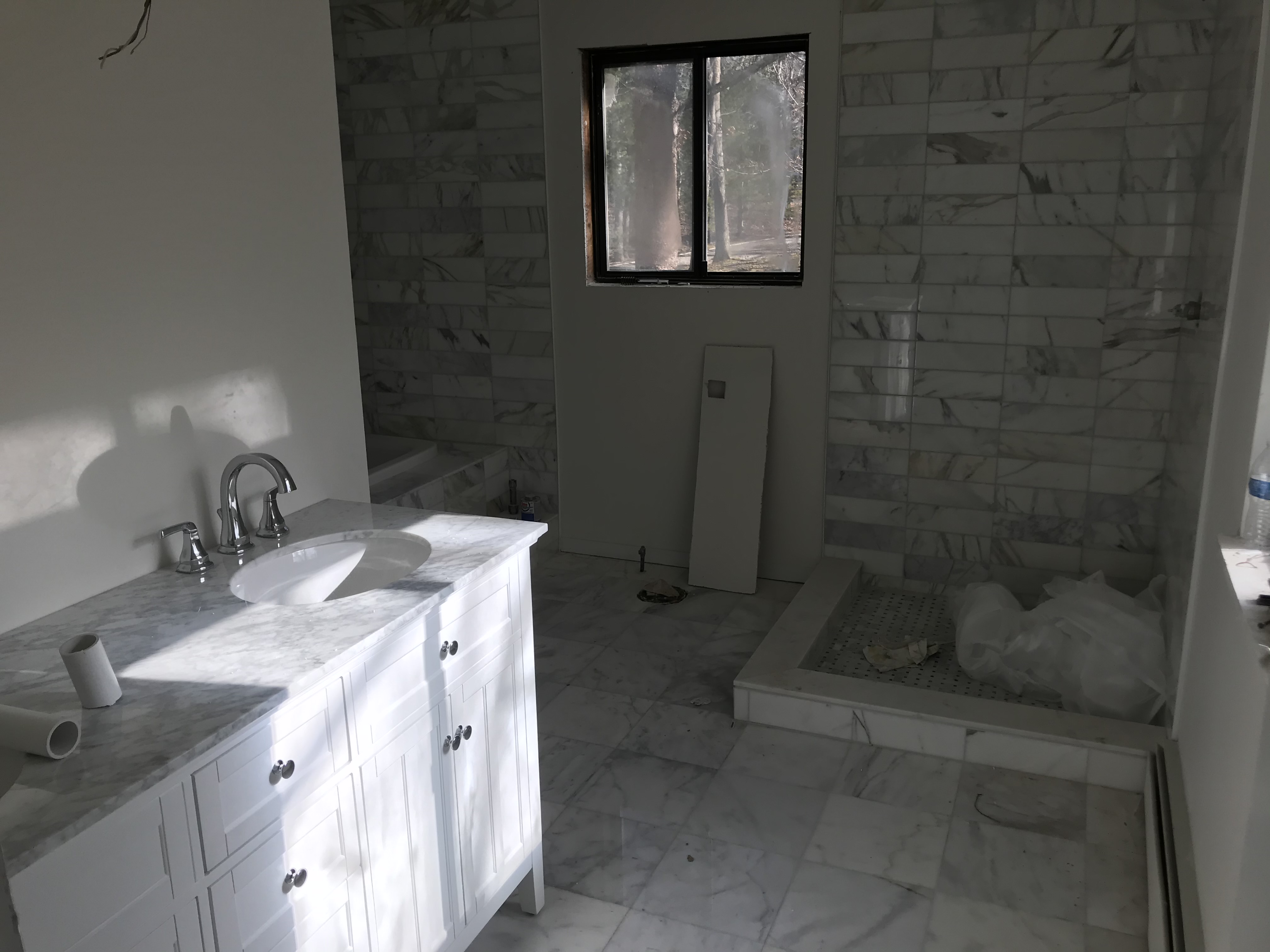 Marble tile installation progress — shower area