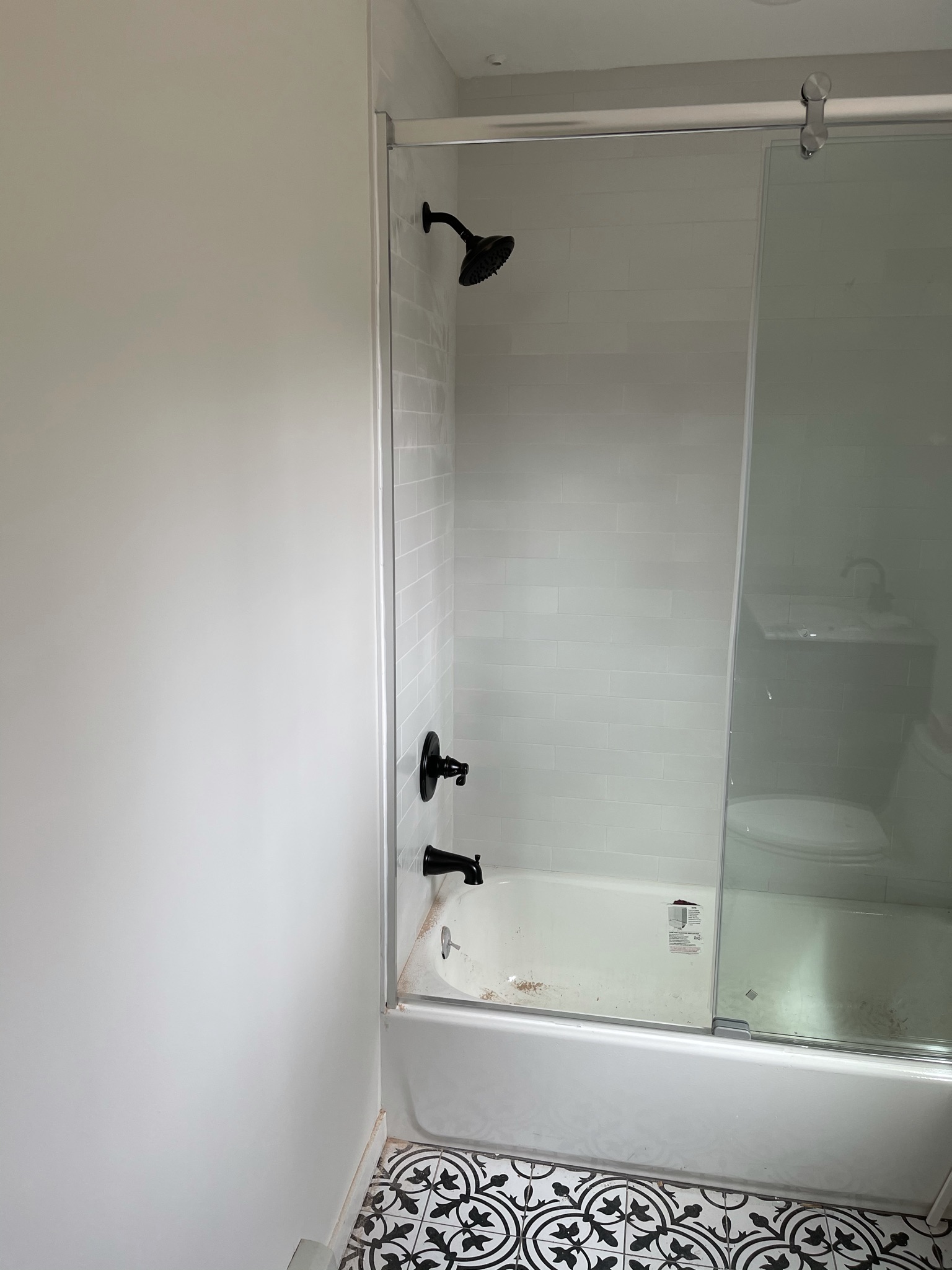 Gray vanity with hexagon marble tile floor and new toilet