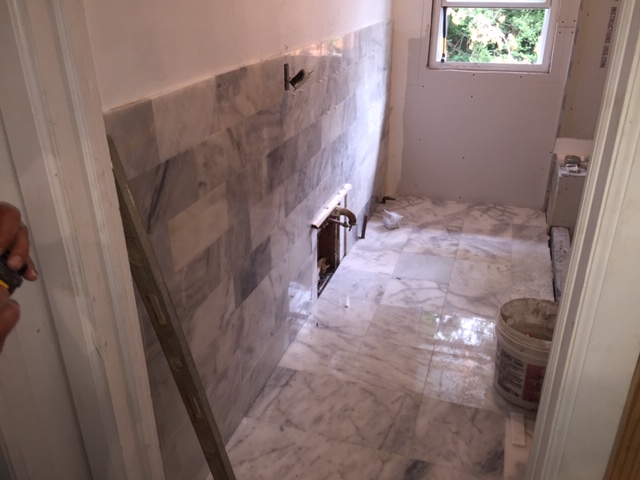 Bathroom during — marble wall tile installation in progress