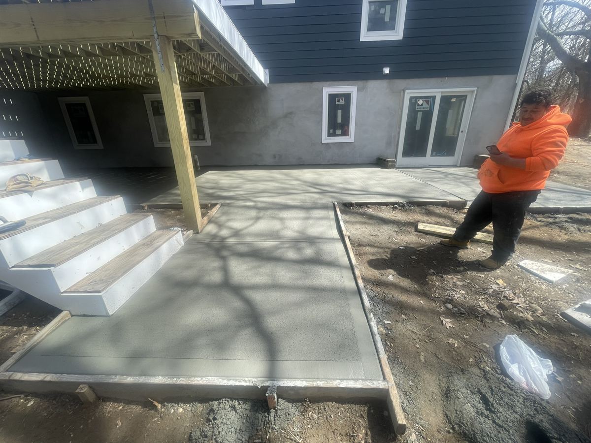 Finished concrete patio and walkway at a renovated house